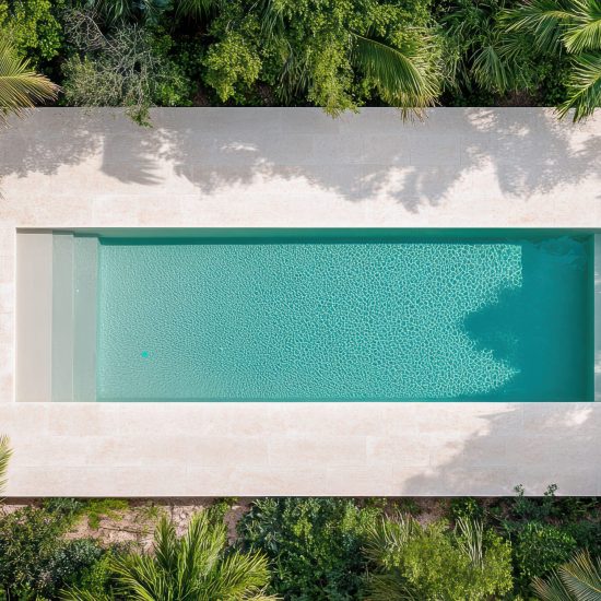 Modern villa with pool surrounded by lush greenery, offering serene escape